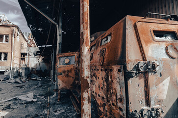 burnt military armored car on the street of the ruined city