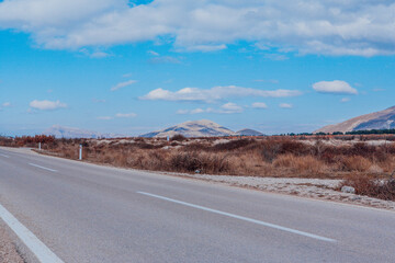 The asphalt road among the mountain landscape. Travel background for publication, design, poster, calendar, post, screensaver, wallpaper, cover, website. High quality photo