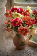 Still-life. photo of a bouquet of bright dahlias on the window.