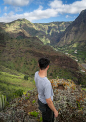 Fototapeta premium Young man contemplates the landscape. Agaete Valley. Gran Canaria. Canary Islands