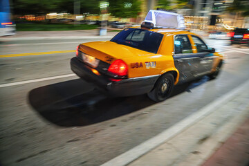  Cars and taxis in movement with motion blur in USA, Miami. Night life.