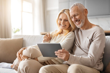 Happy Senior Couple Enjoying Digital Gadget World Using Their Tablet