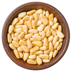 Roasted pine nuts in the wooden bowl,a isolated on the white background, top view.