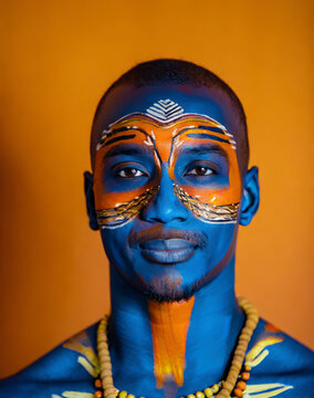 portrait African man with painted face in indigenous culture
