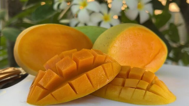 Ripe Mango fruit rotating over white background. Close-up of fresh juicy tropical mango, healthy sweet dessert, vegan food. Isolated on white background. High quality 4k footage