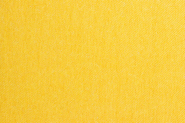 Close-up yellow or golden mustard fabric surface texture, yellow gold orange mustard brown abstract...