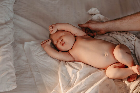 Portrait of newborn baby in bed