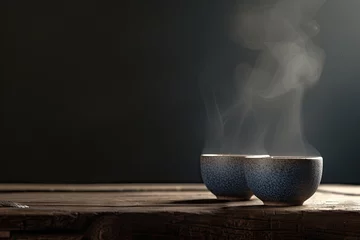Selbstklebende Fototapeten Two steaming cups of hot tea on dark wooden table capturing moment of warmth and aroma closeup of cups reveals delicate steam rising suggesting fresh and tasty beverage perfect for breakfast or break © Bussakon