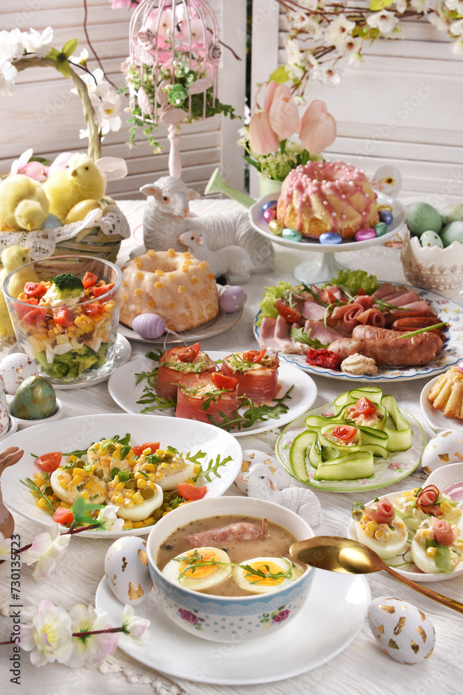 Wall mural Easter table with traditional white borscht, deviled eggs, salads and pastries