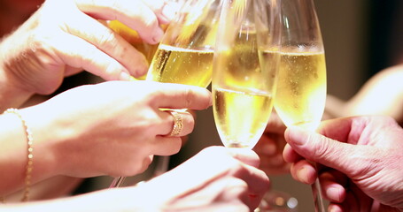 Clinking champagne glasses in celebration