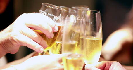 Clinking champagne glasses in celebration