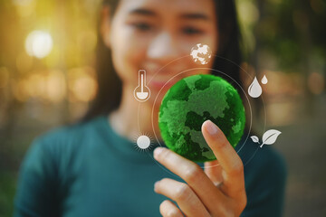 Female hand holding a green ball, ESG values and promoting the net zero concept for a sustainable...