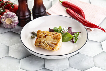 Roasted cod fish steak with salad