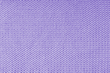 Close up background of knitted wool fabric made of viscose yarn, purple color wool knitwear texture. Sweater, pullover knitted jersey background. Fabric abstract backdrop, wallpaper