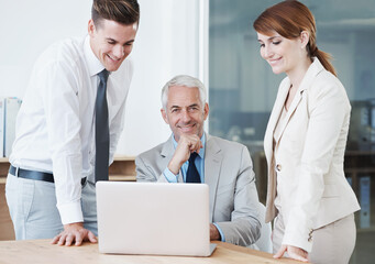 Laptop, portrait and manager with business people in office for corporate legal project meeting. Discussion, technology and professional team of lawyers work on computer by desk together in workplace