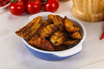 Golden baked potato Idaho with spices