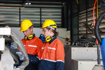Caucasian Technicians Collaborating in Industrial Workshop