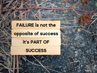 Inspirational motivational quote. Failure is not the opposite of success, it's part of success. Text on wooden blocks background.