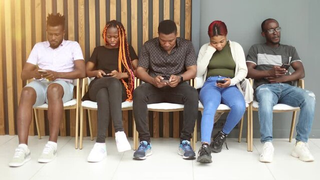 Group of people sleeping on a chair holding smartphones