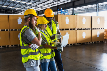 Diversity factory workers men and woman working on laptop in warehouse