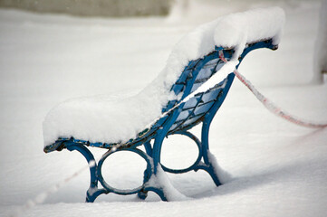 snow covered bench in winter
