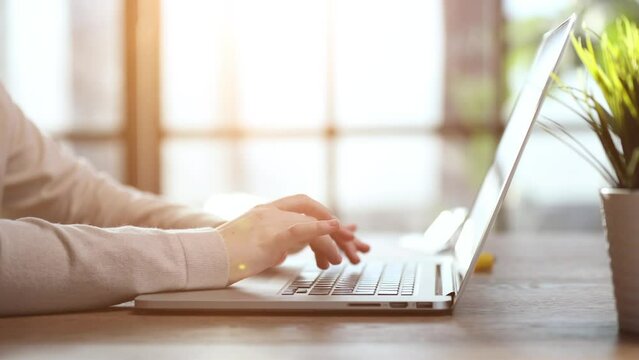 man hand printing jobs using a laptop keyboard at the office.