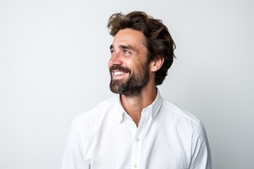 Portrait of a handsome man with beard and mustache smiling over grey background
