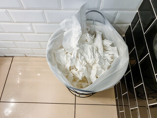 Fototapeta na wymiar Bathroom trashcan filled with used tissues is not related to food, recipe, ingredient, kitchen appliance, cuisine, dish, dairy, cream, buttercream, or major appliance.