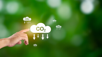 Hand holding CO2 reducing icon for decrease carbon dioxide emission, Business and environment...