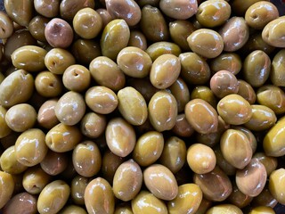 Many Whole Kalamata olives come from the famous Kalamata region of Greece. Lots of olives as a background. Top view. Organic and fresh ready for sale and eating. Mediterranean snacks