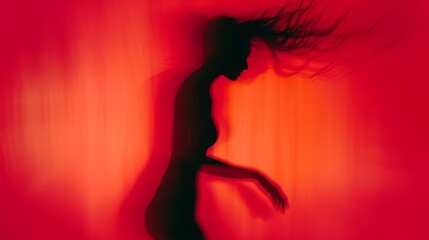 Female blurred silhouette on a red background. Elegant outline of a woman in motion out of focus