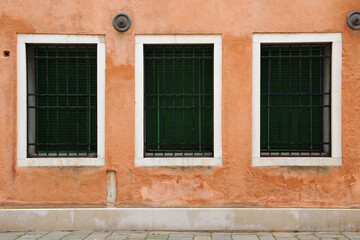 Fototapeta na wymiar Italy, Venice. Three antique windows in an old house.