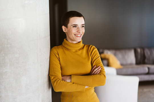 Young Woman with Short Hair Enjoying Relaxing Moment in Stylish Living Room