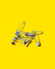 Fototapeta premium Safety Pins on Yellow Background