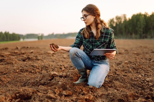 Woman farmer checking soil health before growth a seed of vegetable or plant seedling. Agriculture, gardening or ecology concept