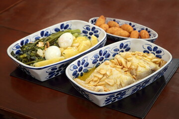 oven-baked cod with thin slices of garlic and olive oil. Served with broccoli, eggs and boiled potatoes