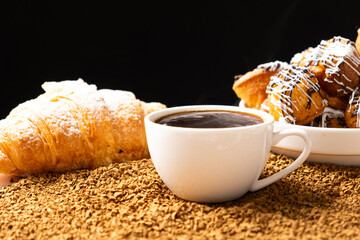 A cup of instant coffee granules and scones. Beautiful and delicious breakfast.