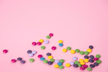 A pink web background with colorful chocolate candies perfect for a party, birthday or Valentines's day