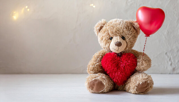 Plush bear holding a heart shaped balloon on light background with copy space