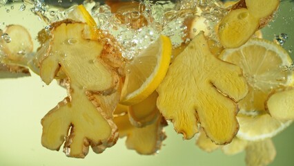 Freeze Motion of Ginger and Lemon Slices Falling into Water. - 730185355