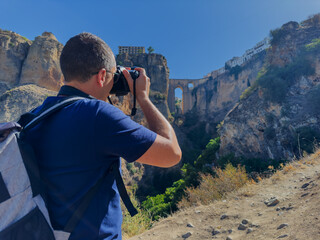 Man tourist take pictures of famous Puente Nuevo in Ronda