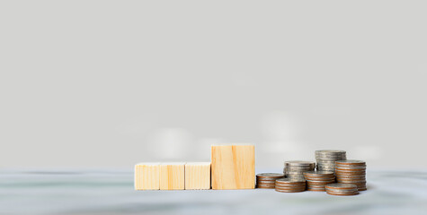 Rows of coins on wooden cubes, Financial business investment, Growing money, Money saving and...