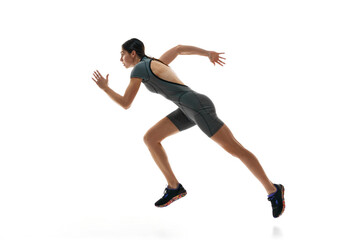 Athletic young woman, female runner, athlete in motion, training, running against white studio...