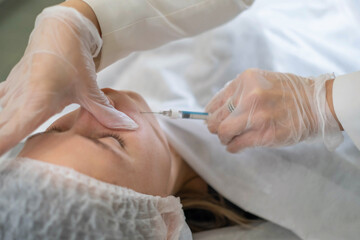 Injection technique on nasolabial lines by a skincare specialist. This is a modern approach to maintaining a youthful appearance.