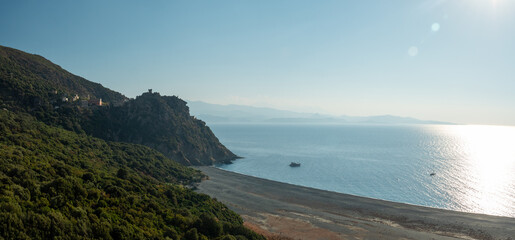 Drone photography of Nonza black beach with black pebbles and turquoise waters in Cap Corse