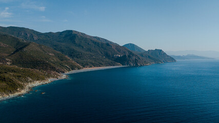 Obraz premium Drone photography of Nonza black beach with black pebbles and turquoise waters in Cap Corse