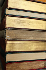 Stack of vintage hardcover books with sprayed gold edging.
