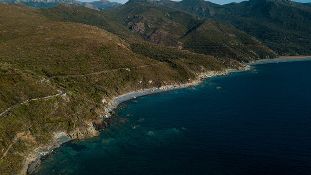 Drone photography of Nonza black beach with black pebbles and turquoise waters in Cap Corse © Sylvain
