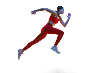 Fototapeta na wymiar Competitive, concentrated young woman, runner, athlete in motion training, running over white studio background in neon light. Concept of sport, active and healthy lifestyle, sportswear, competition