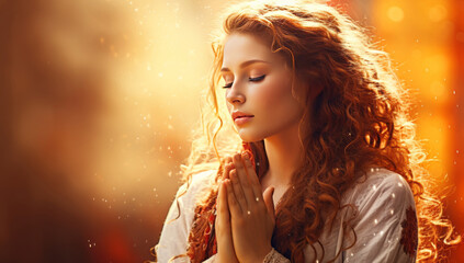 Naklejka premium A young woman praying in the golden sunlight, youthful, cute and dreamy religious image. Lonely boy prays.